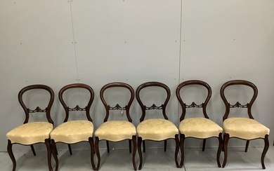 A set of six Victorian walnut balloon back dining chairs...