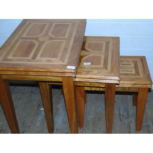 A set of three quality graduated oak side tables with applie...