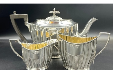 A three piece silver tea service by Lee & Wigfull with a sem...