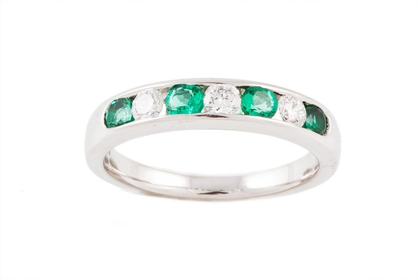AN EMERALD AND DIAMOND HALF ETERNITY RING, with emeralds of ...