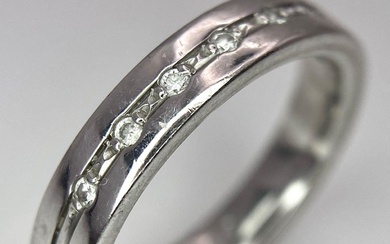 An 18 K white gold, diamond set band ring,...