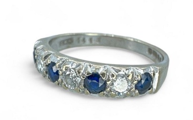 An 18ct white gold sapphire and diamond half hoop ring....