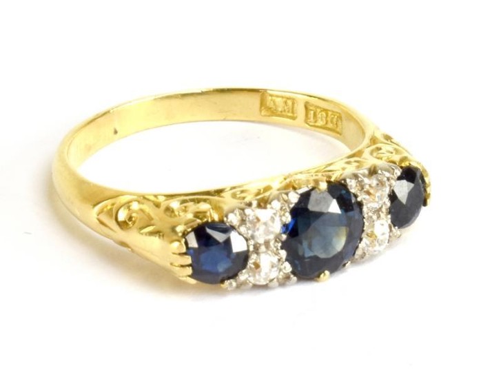 An 18ct yellow gold diamond and sapphire ring, the...
