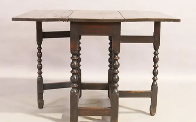 An English oak gateleg table, 17th century, the rectangular drop leaf top...