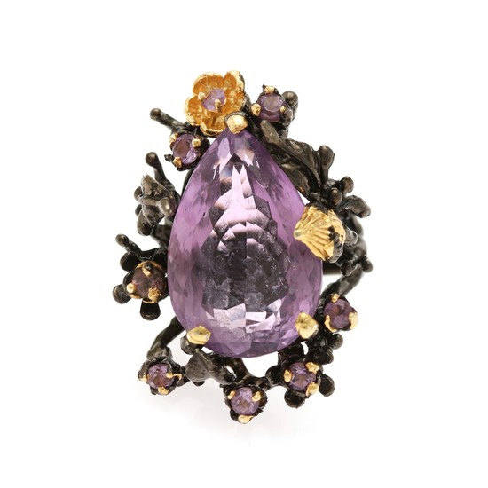 An amethyst ring set with a pear shaped and eight circular-cut amethysts, mounted in black rhodium-plated and partly gilded sterling silver.