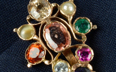 An early to mid 20th century gold Navaratna type clip, the Sri Lankan peach sapphire with yellow, colourless and purplish blue sapphire, pearl, emerald, ruby, cat's-eye chrysoberyl and hessonite garnet surround.