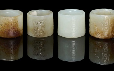 FOUR CHINESE CARVED JADE ARCHERS RINGS, QING DYNASTY, 18TH/19TH CENTURY