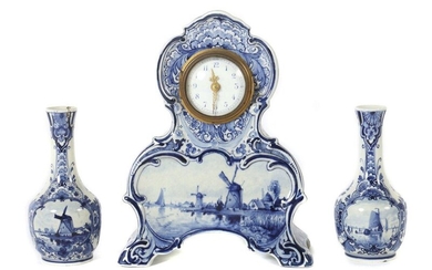 Fireplace clock and two vases Delft, De Koninklijke Delftsche Aardewerkfabriek De Porceleyne Fles (Royal Delft), after 1884, faience, glazed and decorated with underglaze painting in delft blue, frontal cartouches with depictions of Dutch sailing...