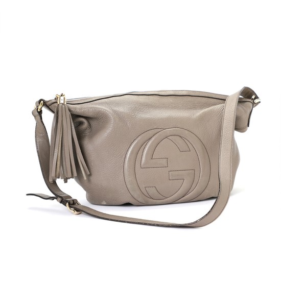 Gucci: A “Soho Messenger” bag made of grey leather with a long adjustable strap, GG logo on the front and one large zipped compartment.