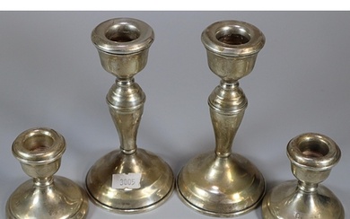 Pair of silver baluster candle sticks together with a pair o...