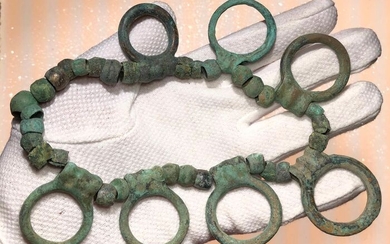 Prehistoric, Bronze Age Bronze Exceptional Necklace composed by barrel-shaped small beads and seven elegantly placed Rings.