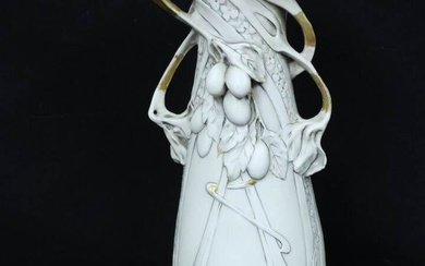 ROYAL DUX. Vase Art nouveau à décor en relief de lianes et fruits, rehauts dorés....
