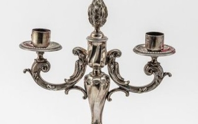 Two-armed candlestick. On a round, stepped and relief-mounted...