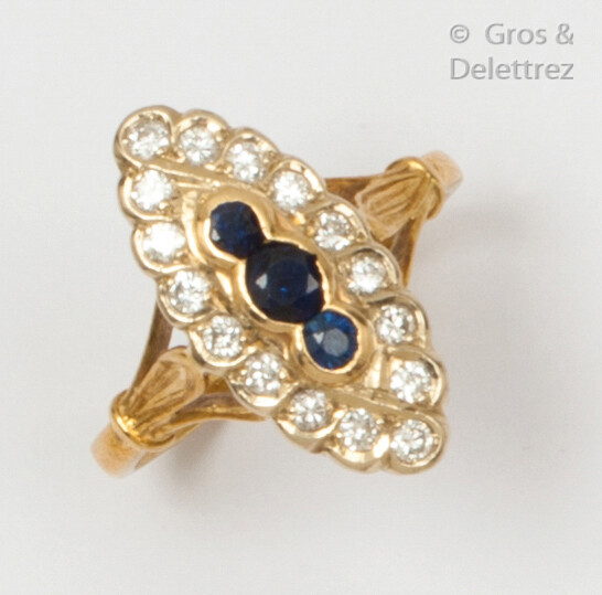 Yellow gold "Navette" ring, set with three sapphires in a ring of brilliant-cut diamonds. Finger size: 54. Rough weight: 4.3g.