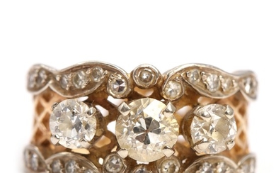 An American diamond ring set with three old-cut and numerous single-cut diamonds, mounted in 14k gold and white gold. Size app. 56.