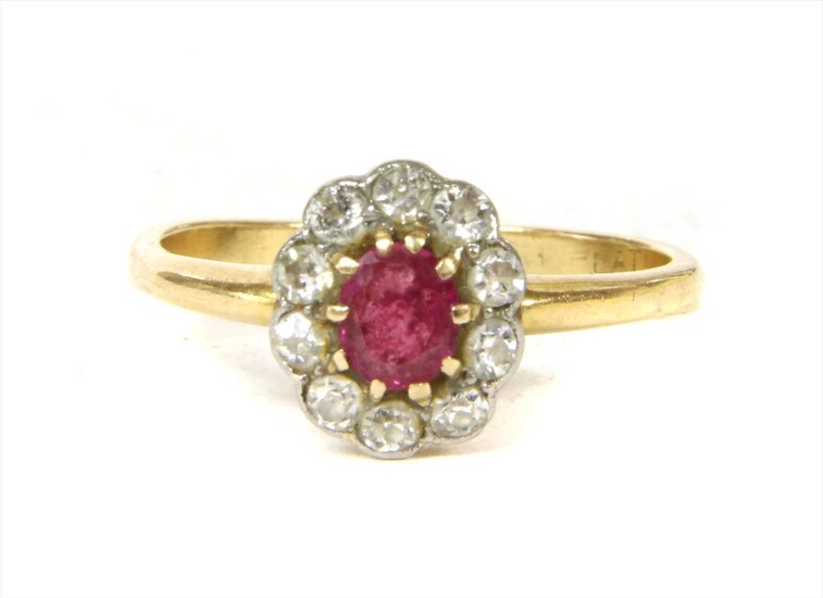 A gold ruby and diamond cluster ring