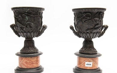 A PAIR OF FRENCH BRONZE URNS WITH DEEP CAST DECORATION ON MARBLE BASES (A/F CHIPS TO MARBLE)