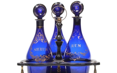 A Set of Three Blue Glass Mallet Decanters and Stoppers,...