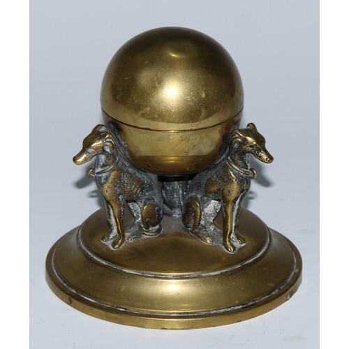 A 19th century brass inkwell, as a sphere supported by three...