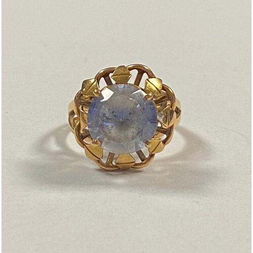 A 20th century dress ring, set with a large round cut sapphi...