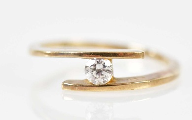 A 9ct yellow gold single stone diamond ring, the tension...