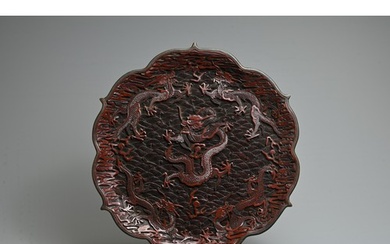 A CHINESE RED LACQUER DRAGON DISH, 19/20TH CENTURY. With bra...