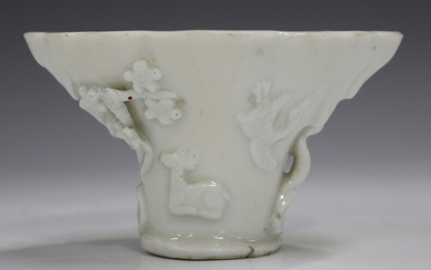 A Chinese blanc-de-Chine porcelain libation cup, probably Kangxi period, of traditional horn form, m