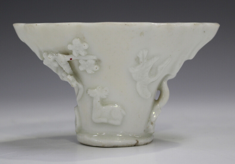 A Chinese blanc-de-Chine porcelain libation cup, probably Kangxi period, of traditional horn form, m