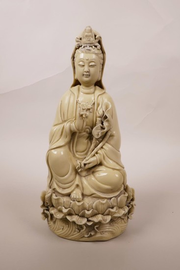 A Chinese blanc de chine Quan Yin seated on a lotus throne, ...