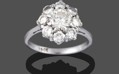 A Diamond Cluster Ring, a round brilliant cut diamond within...