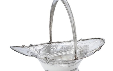 A George III Irish silver swing-handled basket, Dublin, 1790, James Jones, of shaped oval form with reeded border, the foliate pierced sides decorated with bright cut floral garlands to a concave base raised on a pierced oval foot, the handle with...