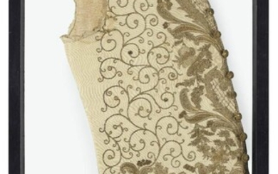 A George III embroidered waistcoat, late 18th century, worked in gilt-wire threads with scrolls, foliage and trelliswork, later mounted in a double glazed frame, 88cm high Provenance: The Erskines of Alva, according to the label.