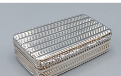 A George IV silver snuff box of ribbed form, with silver gil...