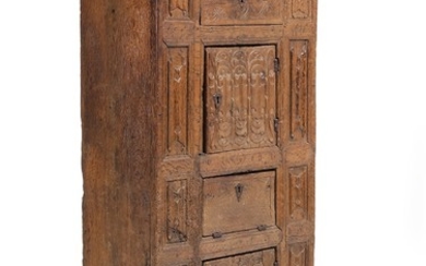 A Gothic oak cabinet, richly carved with folding work and foliage, front with two doors, leaf and drawer. 15th-16th century. H. 169. W. 75. D. 46 cm.