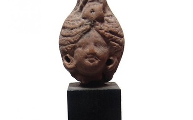 A Greek terracotta head of a woman