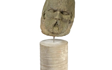 A James I sandstone male head, circa 1620 Carved with prom...