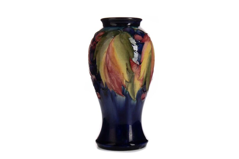 A MOORCROFT LEAF AND BERRY PATTERN VASE