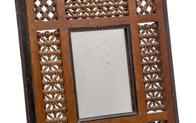 A Mashrabiya framed mirror, possibly retailed by Liberty and Co...