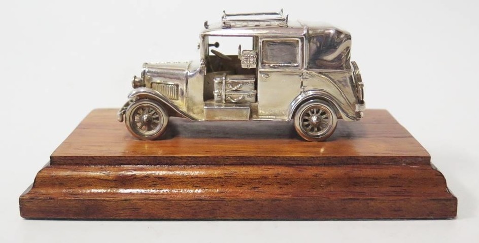 A Modern Silver Model of an Old London Taxi, base 13cm long,...