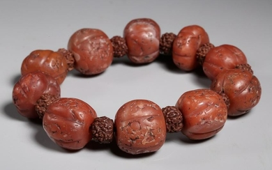 A RED AGATE CARVED BEADS STRING BRACELET