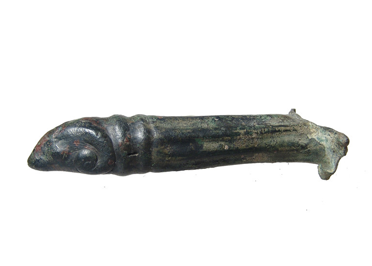 A Roman bronze patera handle in the form of a ram