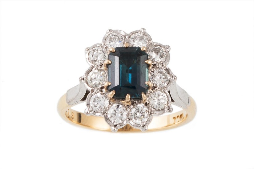 A SAPPHIRE AND DIAMOND CLUSTER RING, the central sapphire su...