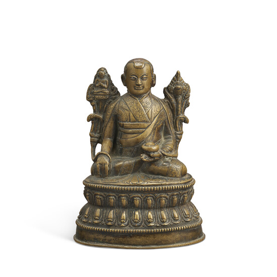 A SILVER-INLAID BRONZE FIGURE OF A LAMA TIBET, 14TH-15TH CENTURY
