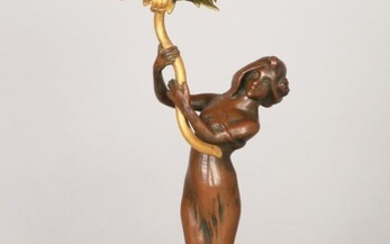 A SMALL BRONZE SCULPTURE IN THE FORM OF A WOMAN HOLDING A GREEN BOWL