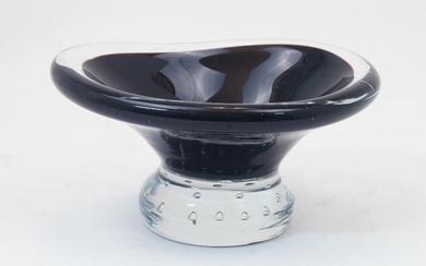 A Scandinavian glass bowl, second half 20th century, of curved triangular form, in black cased glass, on circular controlled bubble base, 7.5cm high, 15.5cm wide