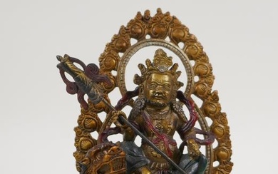 A Sino Tibetan painted bronze figure of a deity...