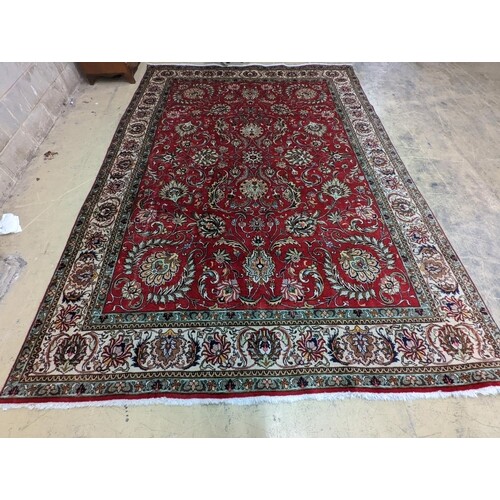 A Tabriz red ground carpet, 400 x 290cm