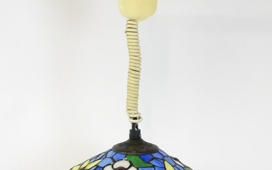 A Tiffany style light shade with floral stained glass style detail and rise and fall style light