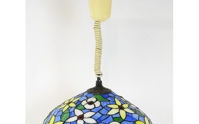 A Tiffany style light shade with floral stained glass style ...