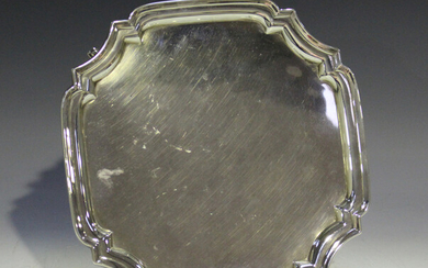 A Victorian silver tea caddy of half-reeded oval form, engraved with a band of foliate pendant garla